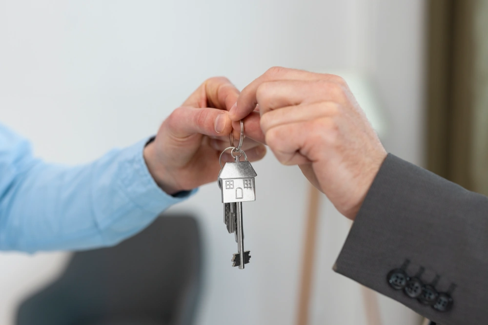 keys being held by real estate agent buyer